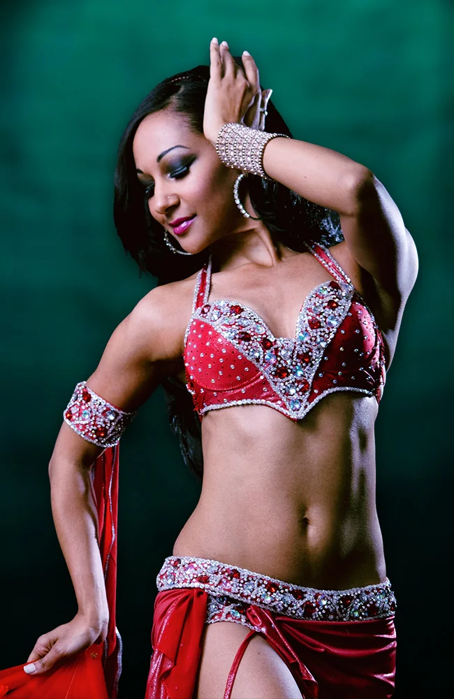 Belly dance hen party dance class in Bournemouth, group in coin scarves mid-shimmy