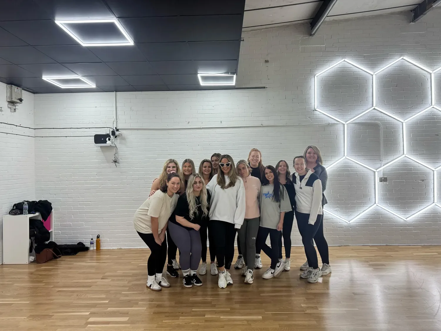 Commercial hen party dance class in Bournemouth group hitting sharp music-video formations