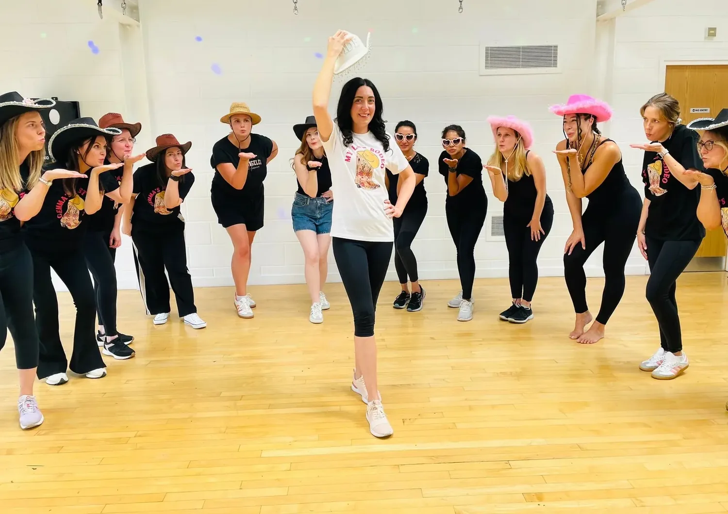 Texas Hold'em hen party group line dancing in cowboy hats in Bournemouth